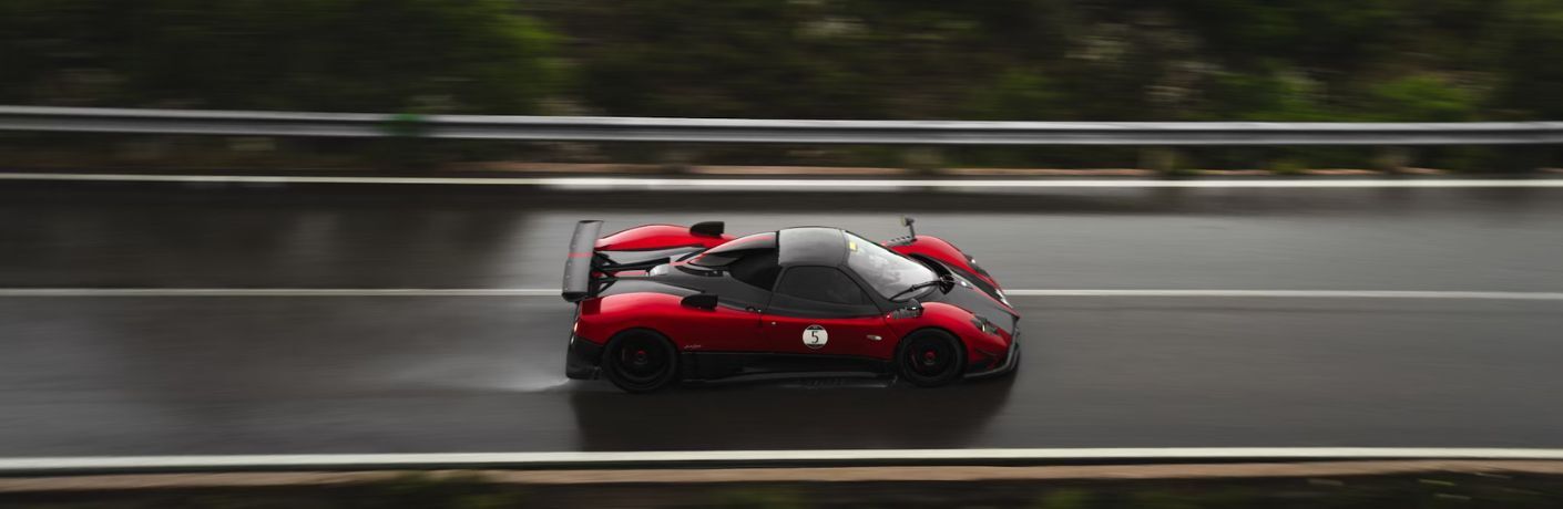 aerial view of a Pagani car on a wet road