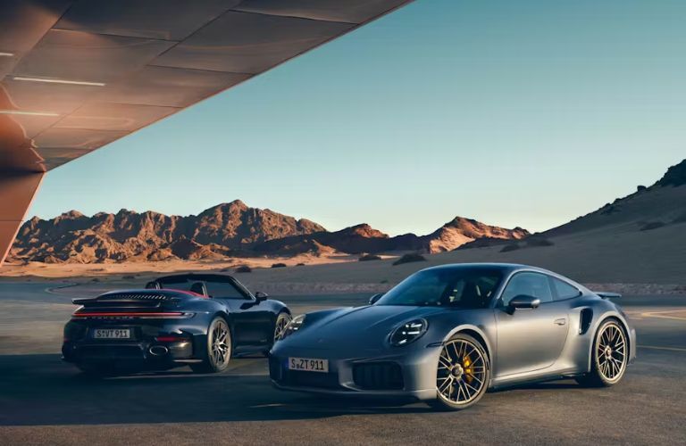 Two 2026 Porsche 911 Turbo S parked outside