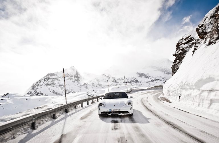 The 2021 Porsche Taycan Turbo S making its way through snow-covered landscape