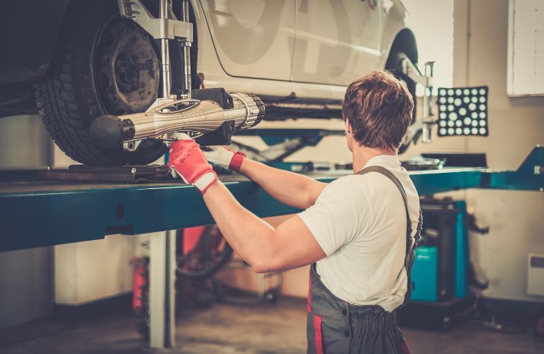 A service professional inspecting a car