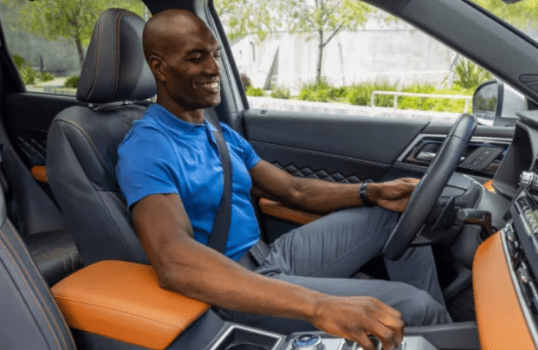 A man driving the 2024 Mitsubishi Outlander