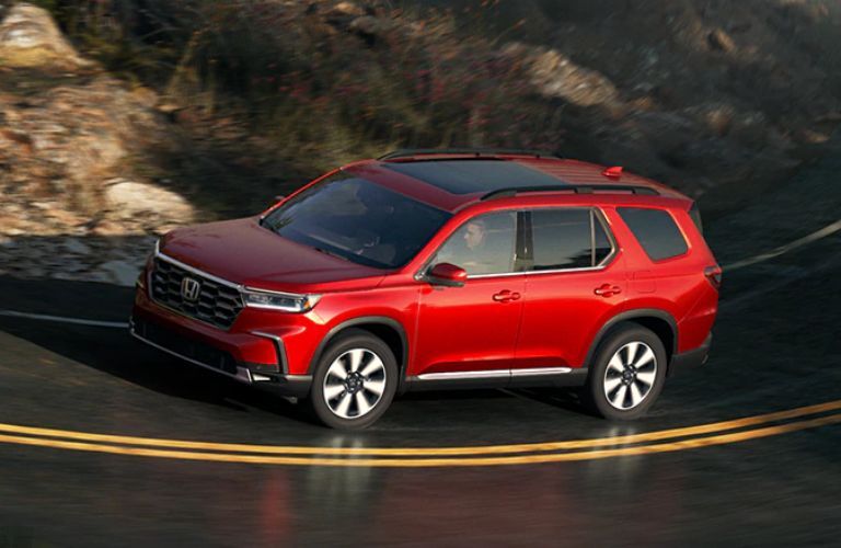 Side view of the 2024 Honda Pilot on a steep road