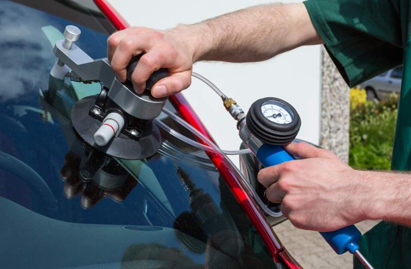 A technician repairing automotive glass.