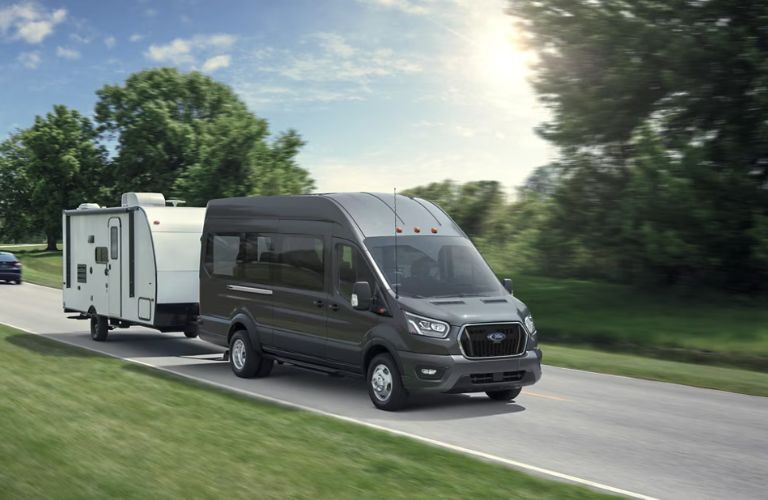 2025 Ford Transit towing a trailer on a road