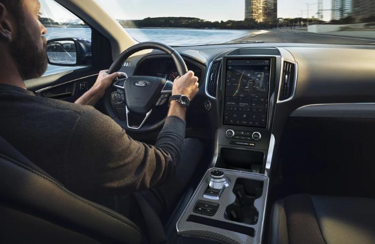 Point of view image of a man driving a 2022 Ford Edge car.