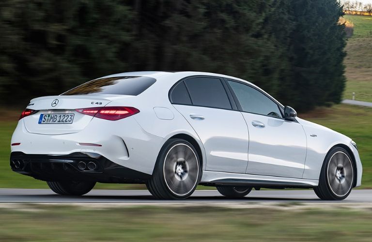 Rear view of the 2023 Mercedes-AMG C 43 Sedan driving on road