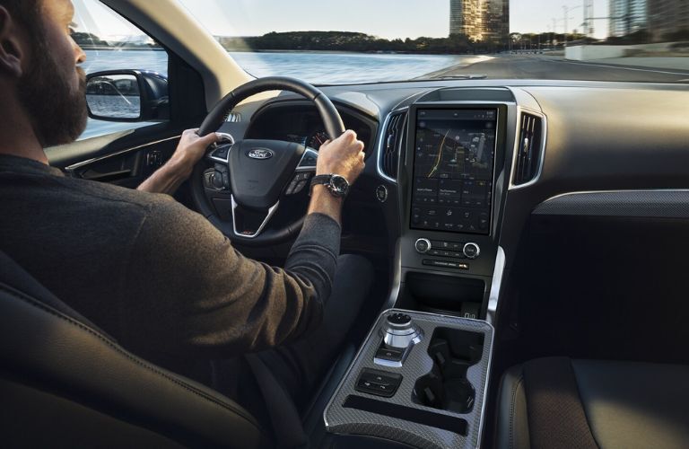 Point of view image of a man driving a Ford Edge vehicle.