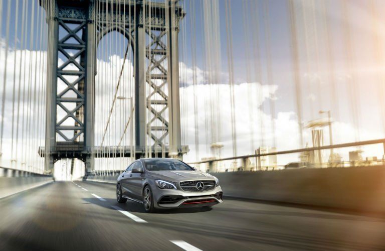 gray 2018 Mercedes-Benz CLA driving across a bridge