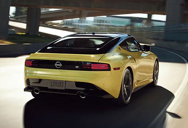 2023 Nissan Z in yellow driving on a highway to illustrate performance.