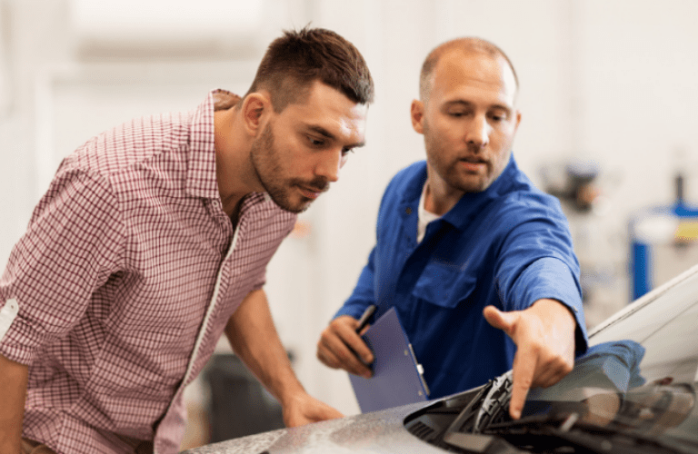 Mechanic and a customer checking a vehicle