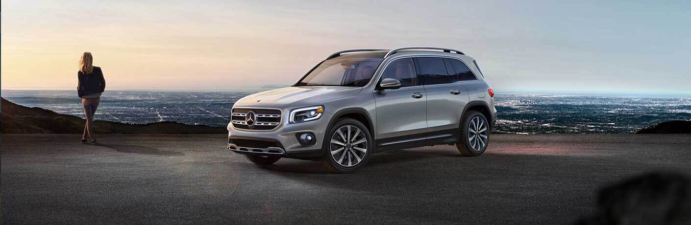 2020 MB GLB exterior front fascia driver side on overlook with woman looking at city below