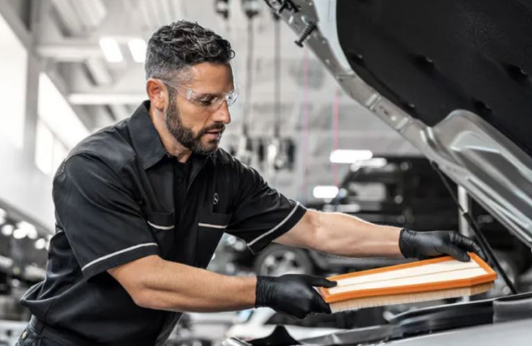 a technician working on a Mercedes-Benz