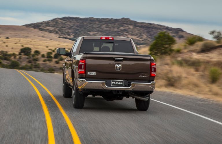 The rear of the 2022 Ram 2500 driving in a country side road
