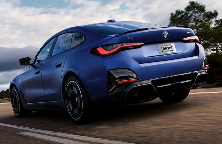 Rear three-quarter view of the 2023 BMW i4 driving