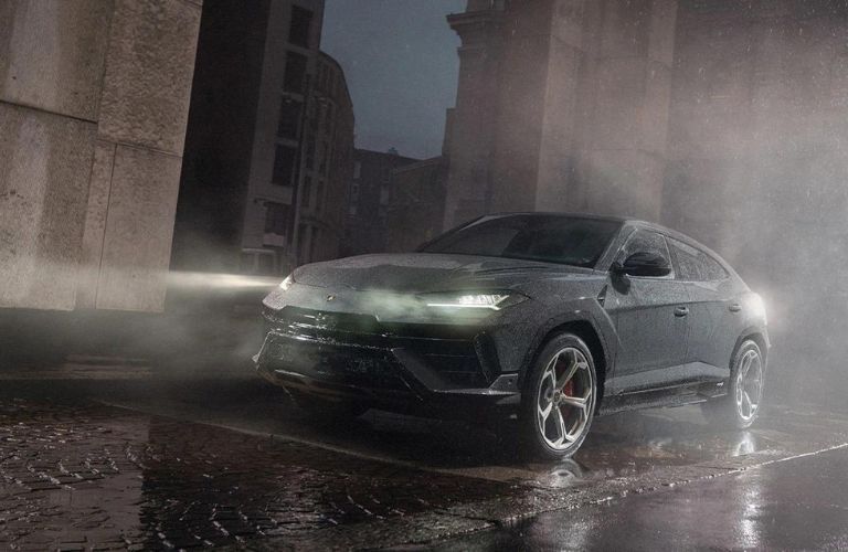 Lamborghini SUV on a road in rain