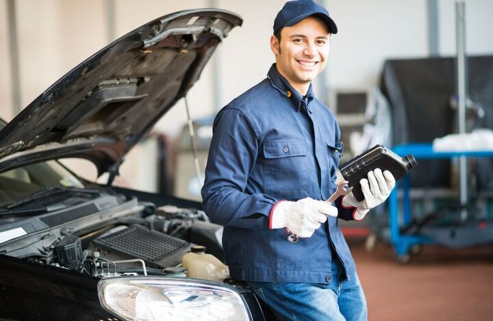 Technician near a open hooded car