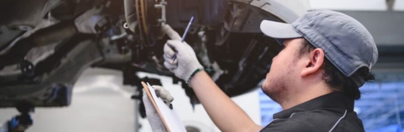 a technician working under a car