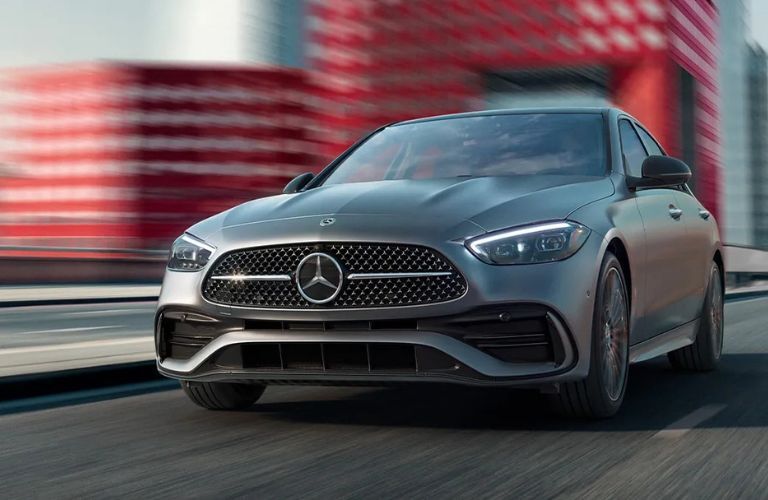 front view image of the 2025 Mercedes-Benz C-Class Sedan on a road