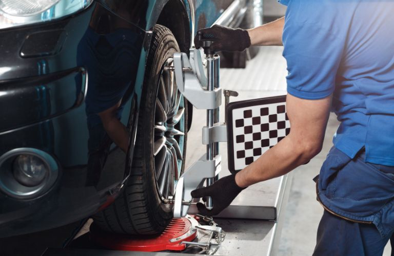 Technician performing a tire alignment service