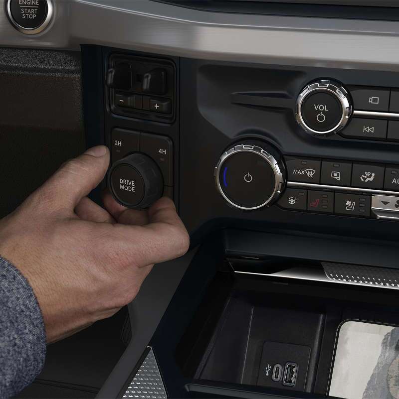 A man selecting one of the drive modes in the 2026 Ford F-450