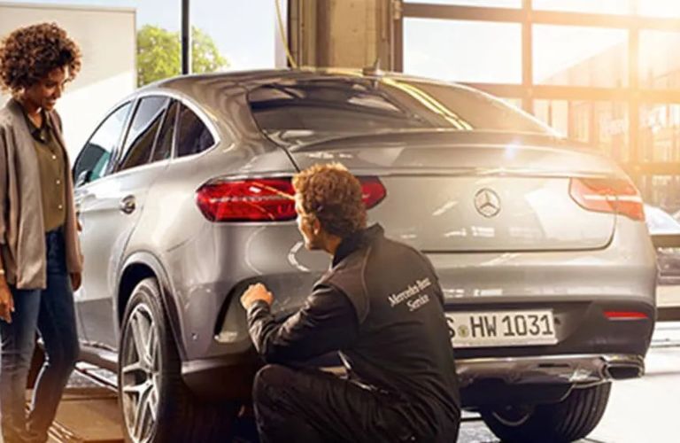 A Mercedes-Benz technician fixing a car