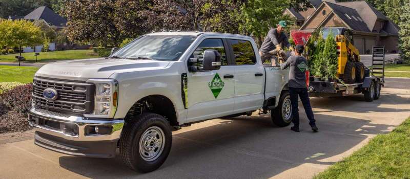 A side external view of the 2026 Ford F-250 towing a large trailer