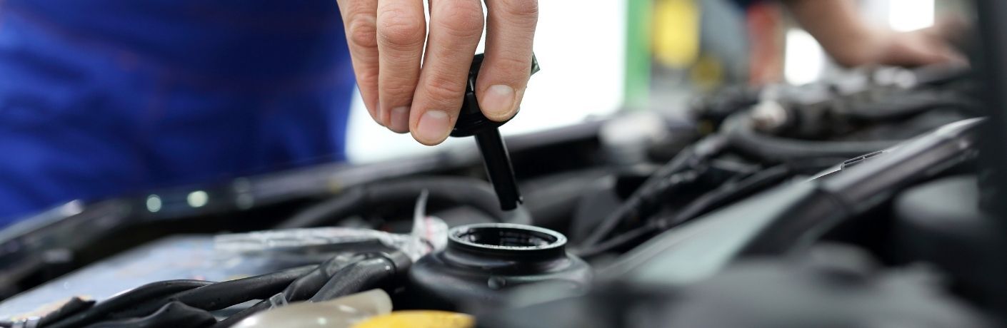 mechanic replacing engine oil cap