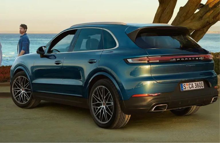 A man standing infront of the 2024 Porsche Cayenne Turbo E-Hybrid SUV