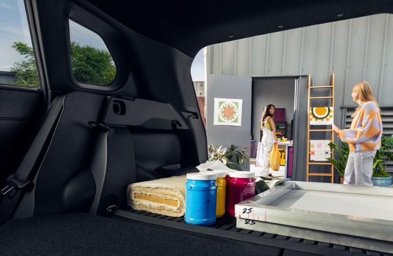 women loading up the cargo space in the 2026 Toyota Corolla Cross