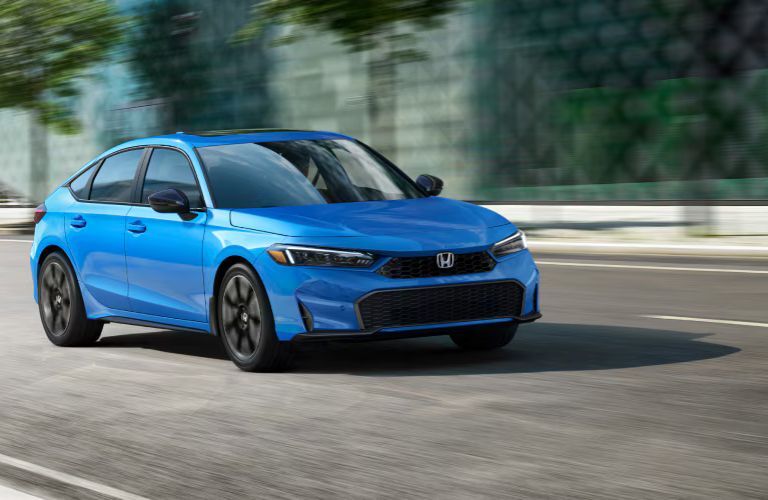 2026 Honda Civic Hatchback Blue on the road