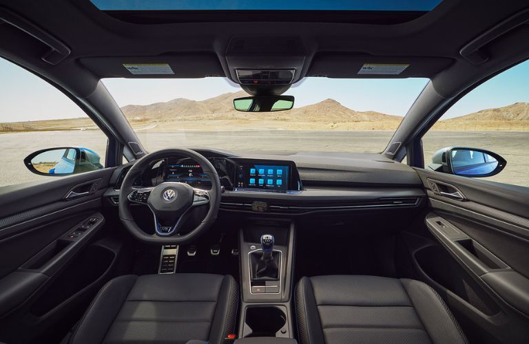 Interior front seating area of the 2022 Volkswagen Golf R is shown.