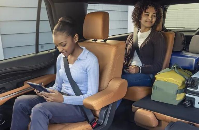 Two kids sitting in a 2022 Ford Expedition is shown.