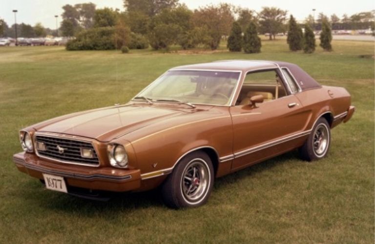 A 1977 Ford Mustang on a grassy terrain