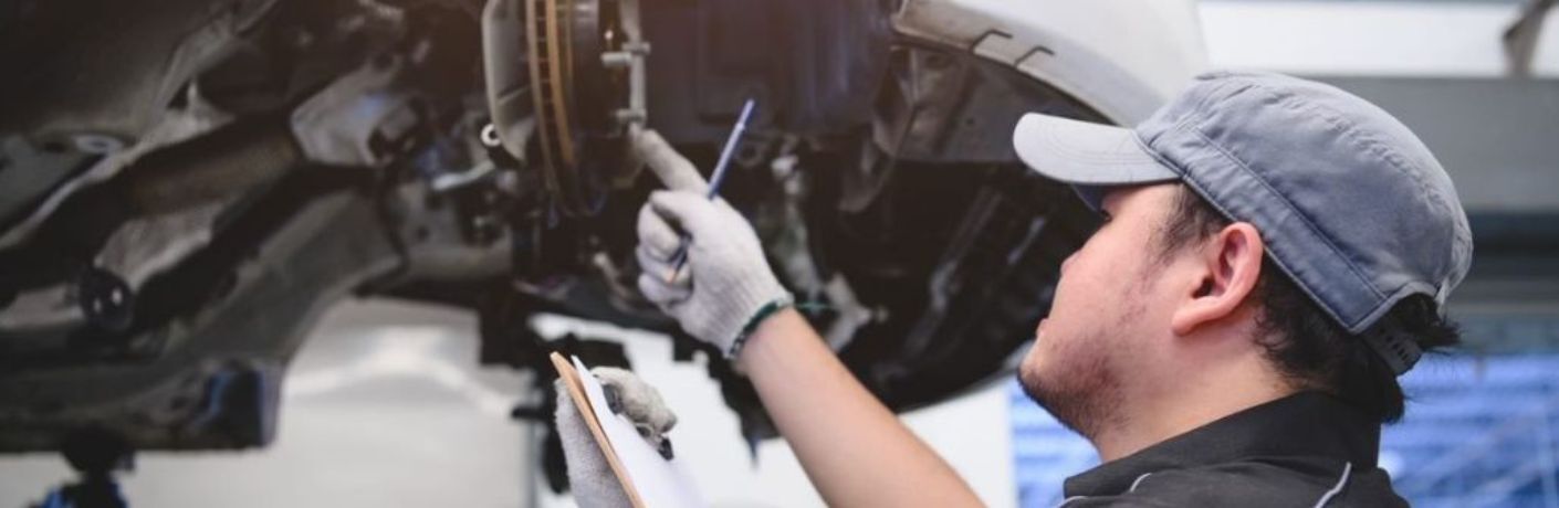 A mechanic checking vehicle's brake