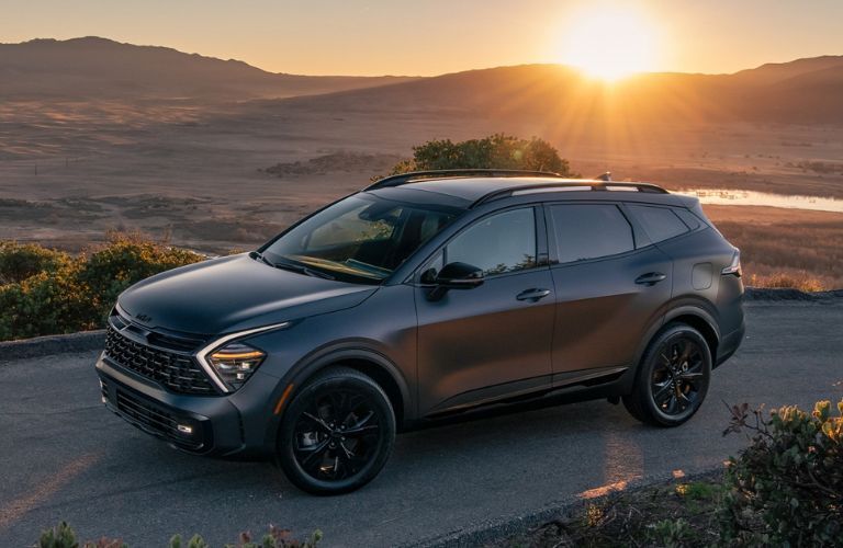 2025 Kia Sportage PHEV on a road by mountains