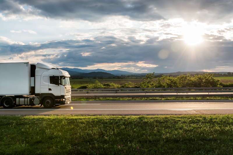 A large commercial truck driving on the highway