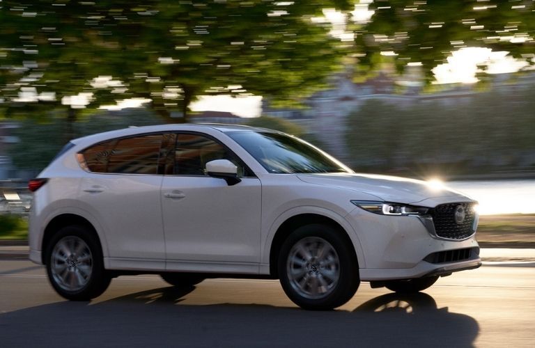 side view image of a Mazda vehicle on a road