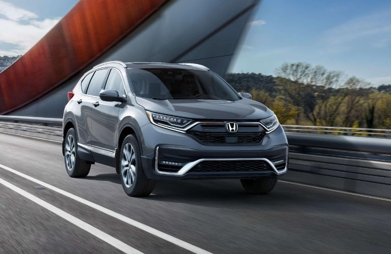 Front view of a silver 2022 Honda CR-V driving on a countryside road