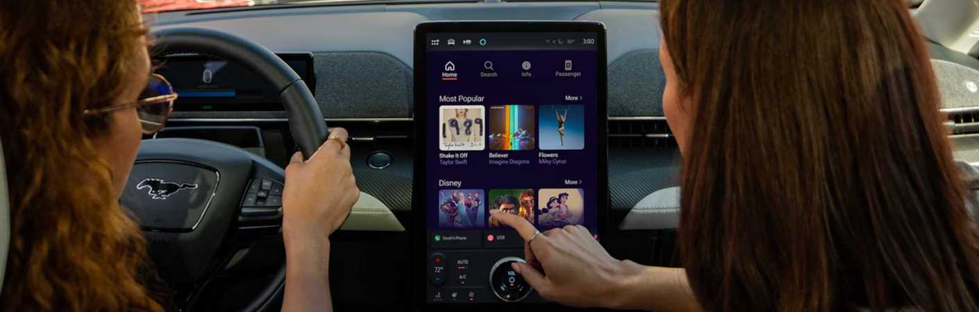 Two women enjoying the infotainment system in the 2026 Ford Mustang Mach-E