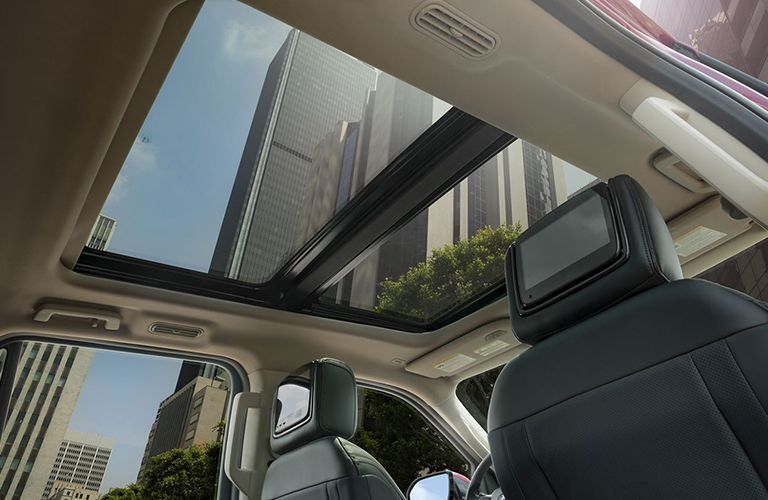 Sunroof of 2019 Ford Expedition looking up at city skyline