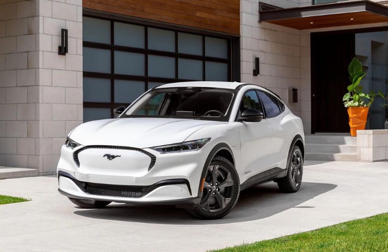 2023 Ford Mustang Convertible parked outside a house