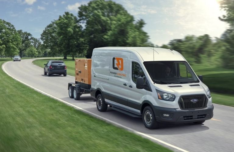 2024 Ford Transit Van with white paint towing a small trailer