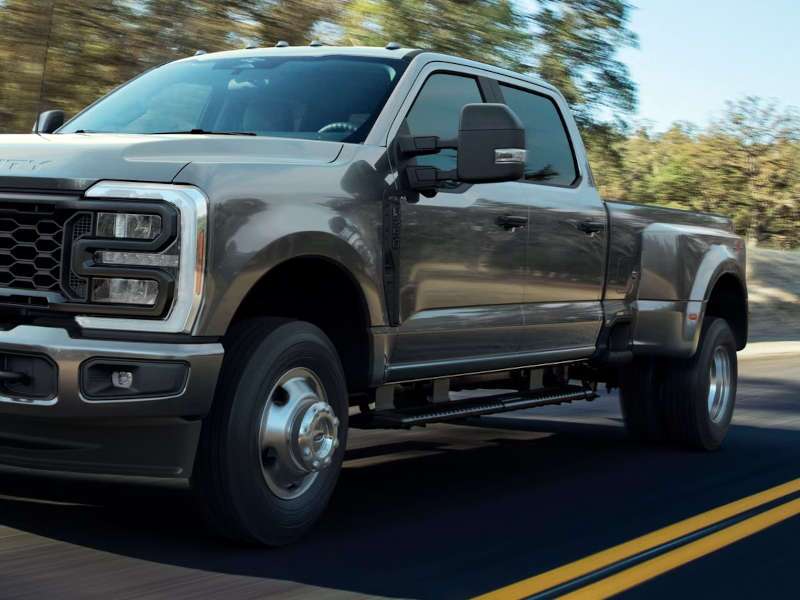 A rugged dual wheel pickup truck on the road
