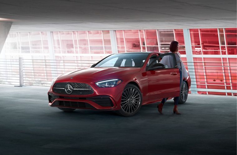 A woman stepping out of a 2026 Mercedes-AMG® C 63 S E Performance Sedan