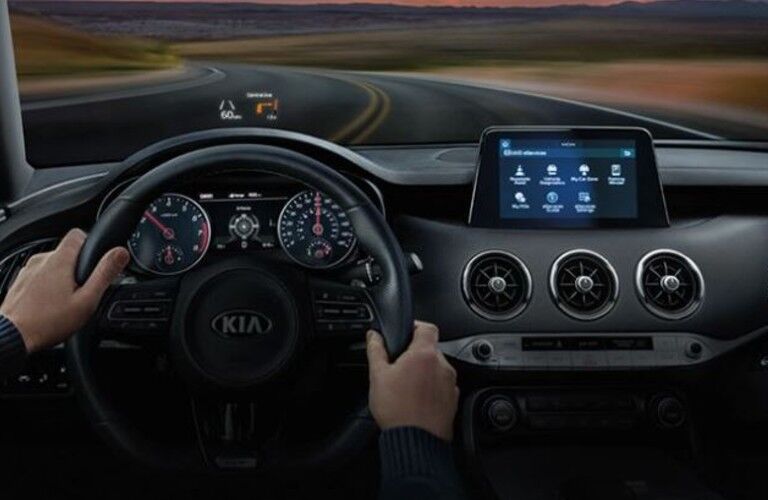 A person driving the 2021 Kia Stinger on a curved roadway