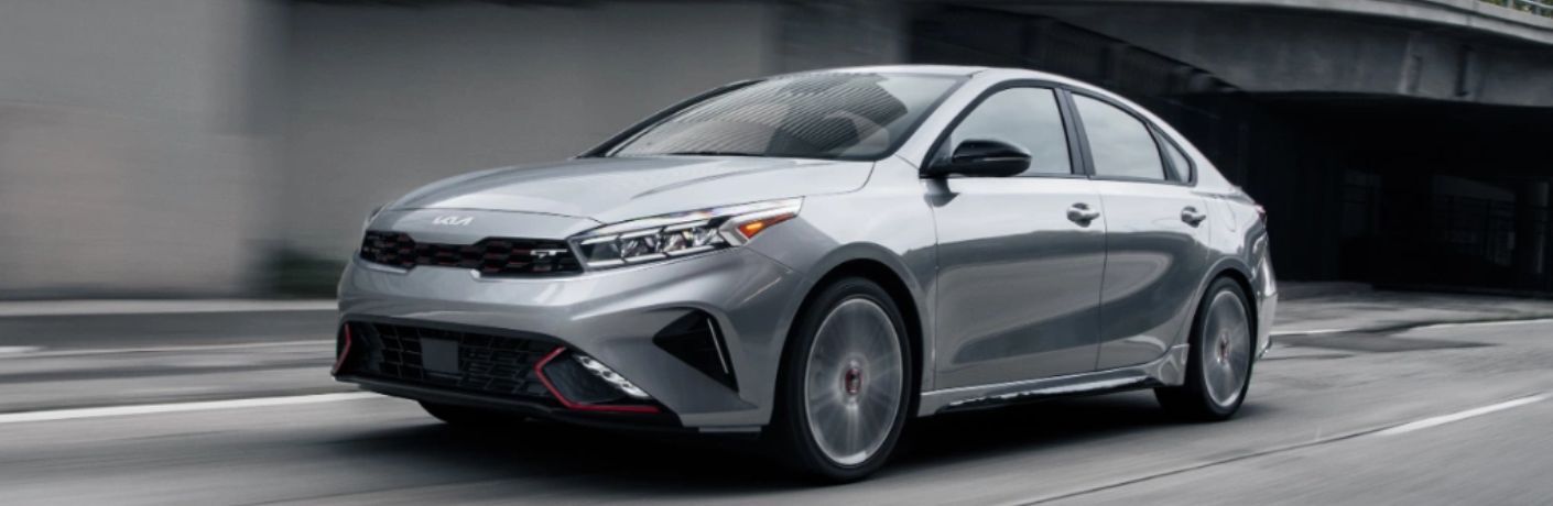 A 2024 Kia Forte speeding on a city road