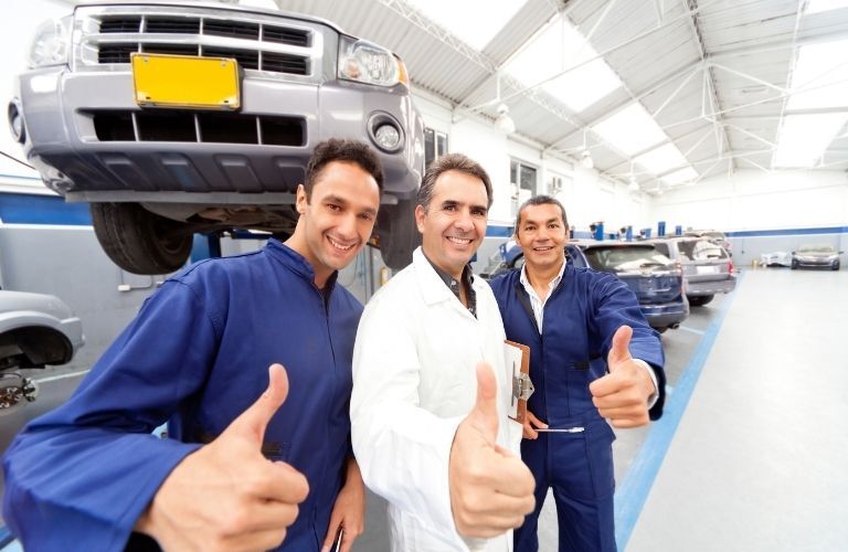 Three Mechanics Giving Thumbs Up