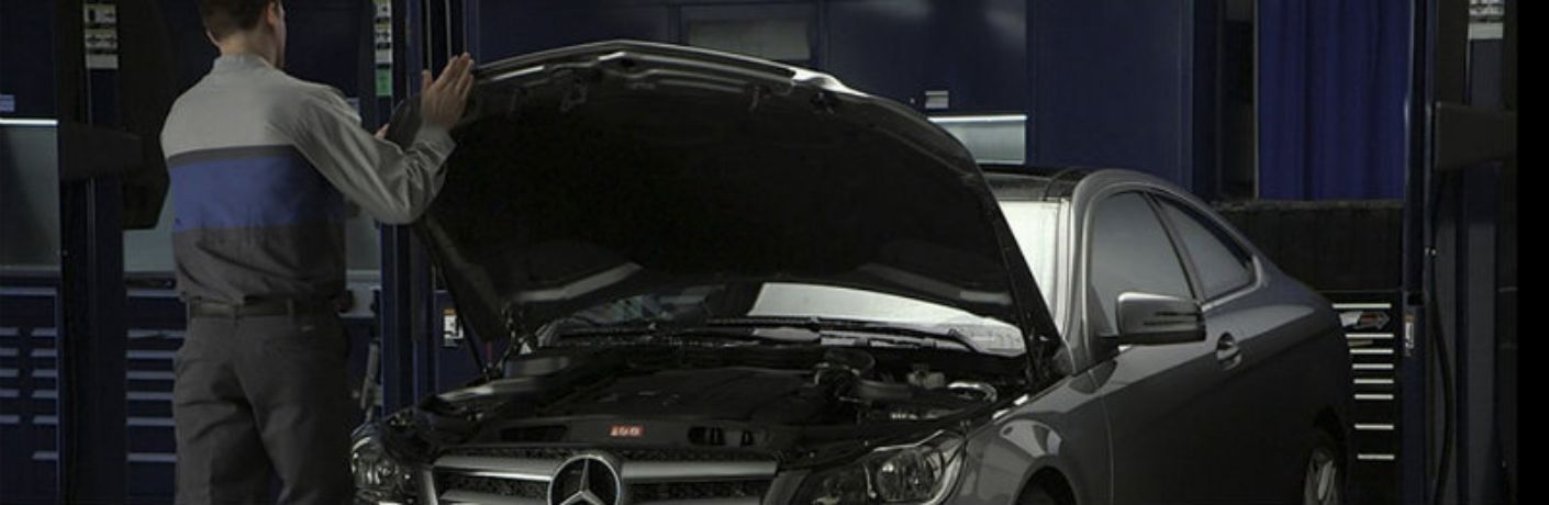 a mechanic working on a Mercedes-Benz