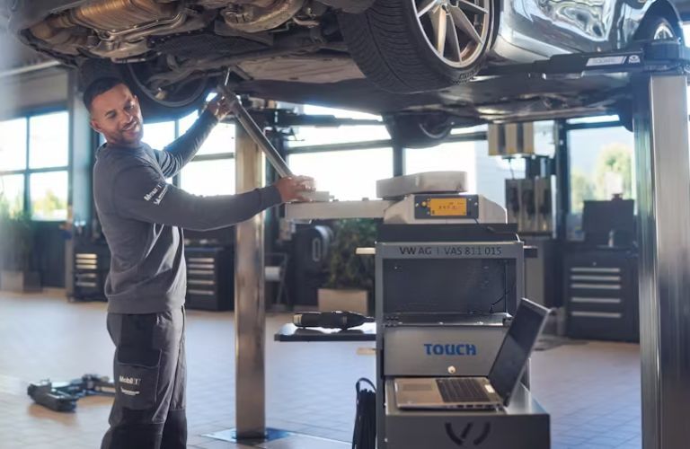 Technician servicing a Porsche