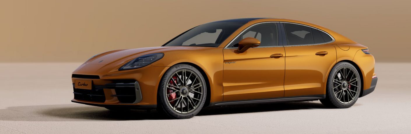 an orange color 2025 Porsche Panamera Turbo E-Hybrid